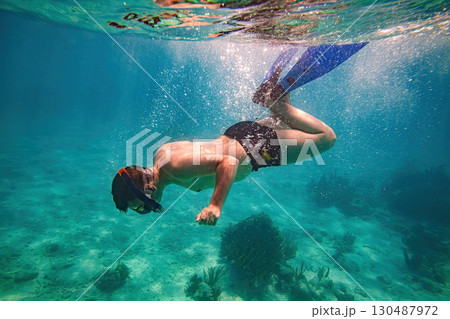 Snorkeling and skin diving on the coral reef edge in tropical waters... 130487972