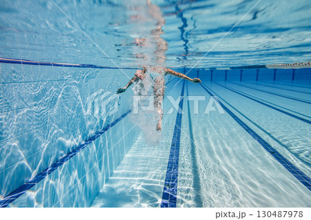 Woman swimming in a swimming pool, Sport swimming pool underwater background... Woman swimming in a swimming pool, Sport swimming pool underwater background... 130487978