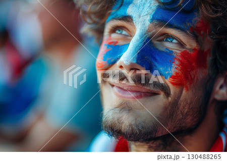 A joyful French man with his face painted in the blue white and red colors of the France flag, cheering at a football match, with a blurred stadium background. AI Generative 130488265