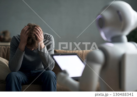 A robot designed like a psychologist chats with a depressed patient, showcasing the fusion of psychology and AI. A robot designed like a psychologist chats with a depressed patient, showcasing the fusion of psychology and AI. 130488341