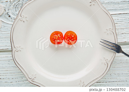 cherry tomato cut open in white plate minimalist cherry tomato cut open in white plate minimalist 130488702