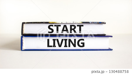 Start living symbol. Concept words Start living on beautiful books. Beautiful white table white background. Business and Start living concept. Copy space. 130488758