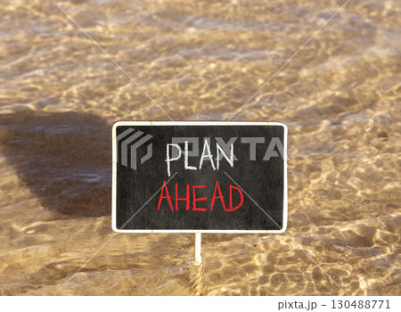 Plan ahead symbol. Concept word Plan ahead on beautiful black blackboard. Beautiful Red sea water background. Black blackboard. Business plan ahead concept. Copy space. 130488771