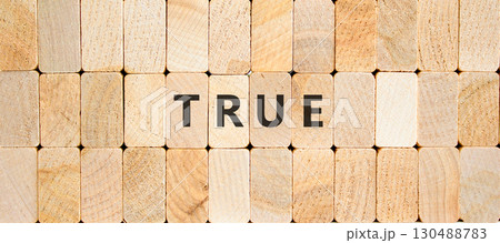 True symbol. Concept word True on beautiful wooden blocks. Beautiful wooden blocks background. Business, lifestyle, support and true concept. Copy space. True symbol. Concept word True on beautiful wooden blocks. Beautiful wooden blocks background. Business, lifestyle, support and true concept. Copy space. 130488783