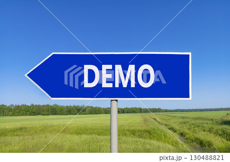 Demo symbol. Concept word Demo on beautiful blue road sign. Beautiful blue sky green grass and forest peaceful nature background. Business and demo concept. Copy space. 130488821