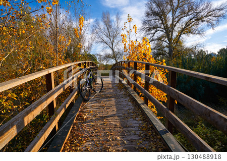 Autumn sunset bike on bridge Parque de Turia Autumn sunset bike on bridge Parque de Turia 130488918