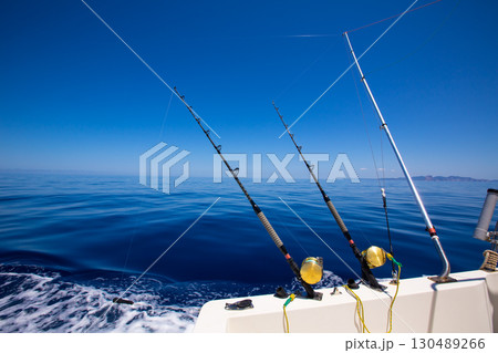 Ibiza fishing boat trolling rods and reels in blue sea Ibiza fishing boat trolling rods and reels in blue sea 130489266