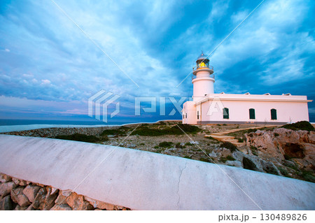 Menorca sunset at Faro de Caballeria Lighthouse 130489826