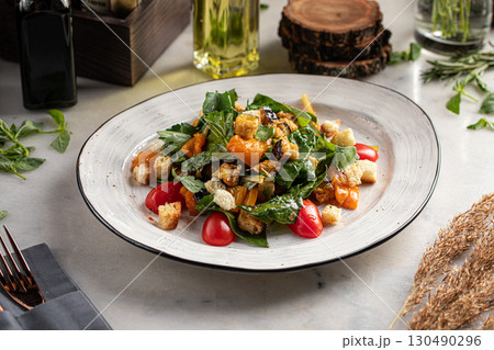 Salad with fried aubergine, tomatoes and croutons 130490296