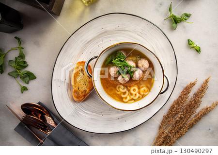 Soup with mini meatballs and pasta in bowl Soup with mini meatballs and pasta in bowl 130490297