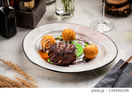 Grilled beef filet with fried potato croquettes 130490299