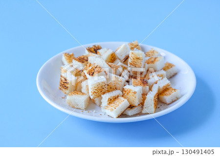 Crispy dry Cubed bread toasted bread on color background. Crispy dry Cubed bread toasted bread on color background. 130491405