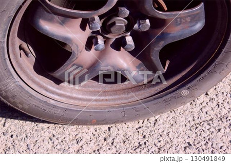 Old, dusty, dirty car wheel, close-up Old, dusty, dirty car wheel, close-up 130491849