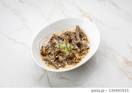 Gourmet beef tongue with creamy sauce, mushrooms and sprouts on marble background 130491933