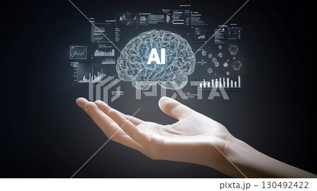 Open hand holding a virtual human brain with ai symbol surrounded by digital data, charts and graphs, representing artificial intelligence, machine learning and data analysis 130492422