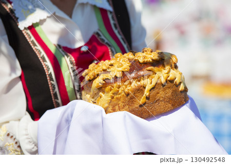 Welcome loaf in hand. Bread and salt as a Russian tradition. Welcome loaf in hand. Bread and salt as a Russian tradition. 130492548