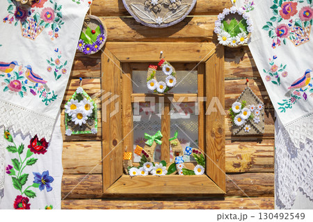 Part of a rustic window of a house decorated with towels. Part of a rustic window of a house decorated with towels. 130492549