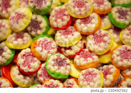 Sweets background. Bright gummy candies close-up. Close-up of colorful jujube background pattern 130492562