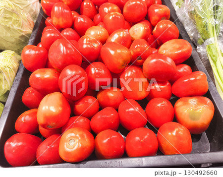 Generous pile of ripe red tomatoes, a fresh and healthy harvest from a local market. Vibrant colors and textures for a food, nutrition, or farm-to-table theme. Generous pile of ripe red tomatoes, a fresh and healthy harvest from a local market. Vibrant colors and textures for a food, nutrition, or farm-to-table theme. 130492660