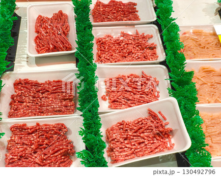 Neatly packaged ground meat (mince) and chicken in a supermarket display in Surabaya, Indonesia. Fresh protein for various culinary uses, ready for purchase. Neatly packaged ground meat (mince) and chicken in a supermarket display in Surabaya, Indonesia. Fresh protein for various culinary uses, ready for purchase. 130492796