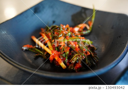 Spicy Korean Chives Kimchi in Black Bowl 130493042