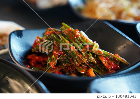 Spicy Korean Chives Kimchi in Black Bowl Spicy Korean Chives Kimchi in Black Bowl 130493043