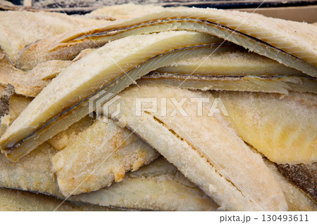 Cod fish salted codfish in a row stacked 130493611