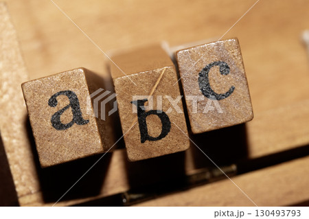 Jumbled up block wood print letters lined up Jumbled up block wood print letters lined up 130493793