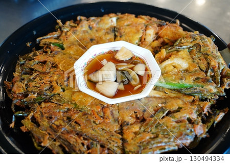 Korean Seafood Pancake (Pajeon) with Dipping Sauce, Delicious Korean Cuisine Korean Seafood Pancake (Pajeon) with Dipping Sauce, Delicious Korean Cuisine 130494334