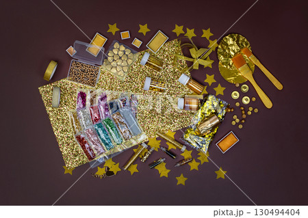 Jewelry designer workplace. Boxes with golden color beads. Accessories for needlework on table. Handmade accessories top view. Jewelry designer workplace. Boxes with golden color beads. Accessories for needlework on table. Handmade accessories top view. 130494404