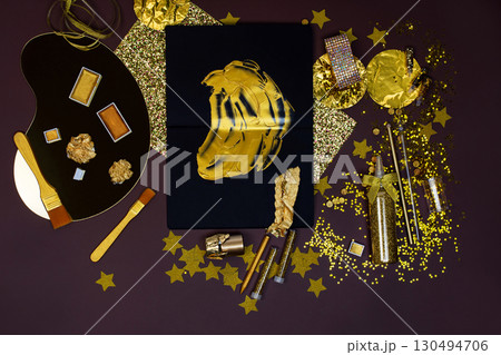 Applying gold paint and gold foil to a work of art. Gilding accessories in golden color for master craftsman. Applying gold paint and gold foil to a work of art. Gilding accessories in golden color for master craftsman. 130494706