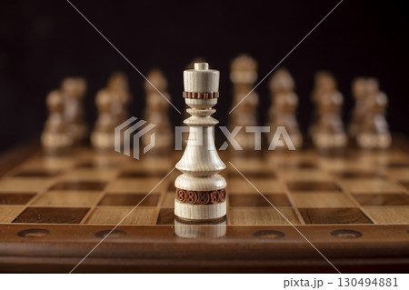 Chess on a dark background. A puzzle game with tricky combinations that requires planning and thinking. Chess on a dark background. A puzzle game with tricky combinations that requires planning and thinking. 130494881