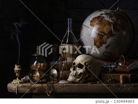 Dark still life with a skull and antique props. Dark still life with a skull and antique props. 130494903