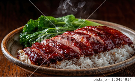 Glazed char siu pork served with rice and bok choy steaming warmly 130494914
