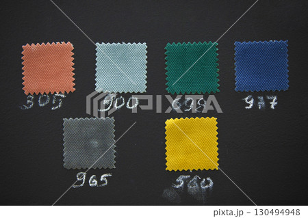 Samples of fabrics for sewing furniture on a dark background. 130494948