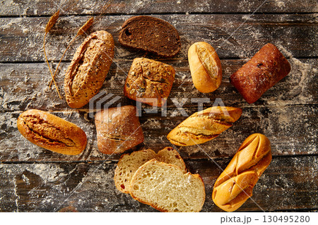 Bread loaf mixed in a rustic wood and wheat flour Bread loaf mixed in a rustic wood and wheat flour 130495280