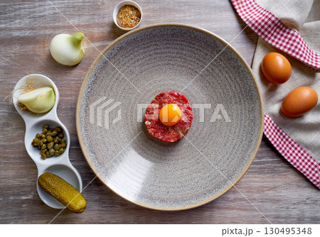Steak Tartare raw meat recipe with egg yolk 130495348