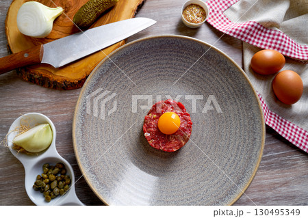 Steak Tartare raw meat recipe with egg yolk Steak Tartare raw meat recipe with egg yolk 130495349