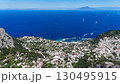 Breathtaking view of Capri's coastline with azure waters and vibrant architecture captures the essence of Italian summer 130495915