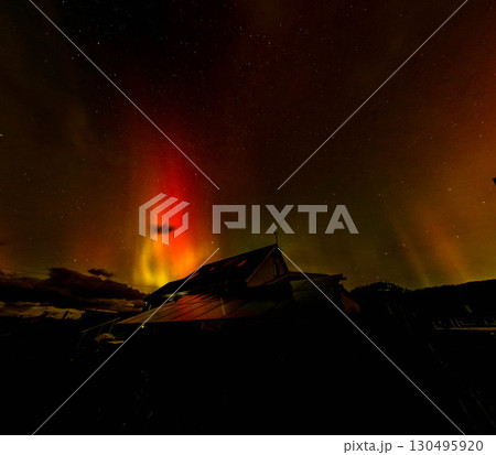 The Aurora Borealis, the northern lights, showing up above bungalow in County Donegal, Ireland 130495920