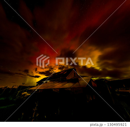 The Aurora Borealis, the northern lights, showing up above bungalow in County Donegal, Ireland 130495921