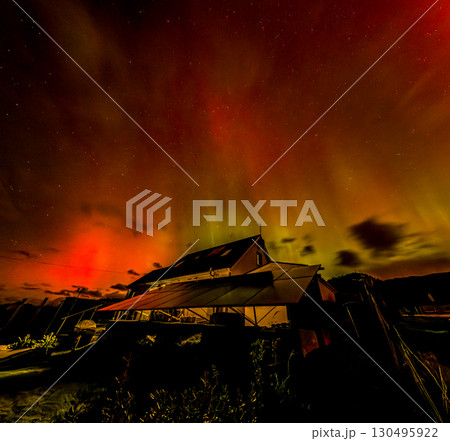 The Aurora Borealis, the northern lights, showing up above bungalow in County Donegal, Ireland 130495922
