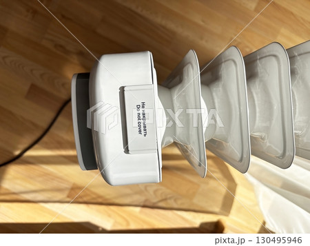 Electric heater with inscription Do Not Cover, top view. Safety rules for device use. Cold weather, beginning of heating season, regulation of room temperature and heating concept 130495946