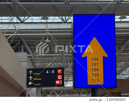Airport direction signs for boarding gates and facilities. Navigation, travel guidance and passenger services in transport hub. Airport direction signs for boarding gates and facilities. Navigation, travel guidance and passenger services in transport hub. 130496065