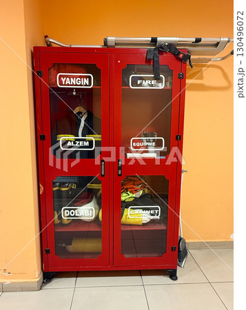 Red fire equipment cabinet in public interior. Safety, emergency response and protective measures in public infrastructure. 130496072