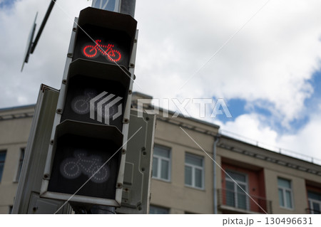 Bicycle traffic light showing red, signaling to stop. Focused on urban infrastructure for cyclists, highlighting the importance of traffic management and safety for eco-friendly transport Bicycle traffic light showing red, signaling to stop. Focused on urban infrastructure for cyclists, highlighting the importance of traffic management and safety for eco-friendly transport 130496631