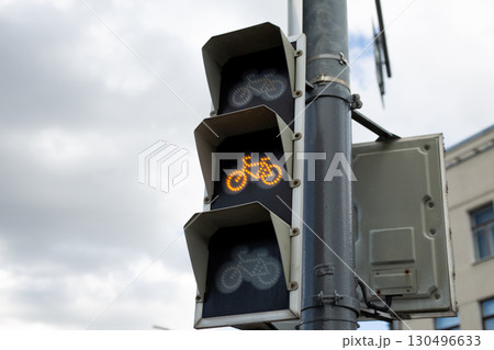 Yellow bicycle traffic light, indicating to slow down and prepare for stop. Highlighting the importance of safe cycling and traffic management in urban environments Yellow bicycle traffic light, indicating to slow down and prepare for stop. Highlighting the importance of safe cycling and traffic management in urban environments 130496633