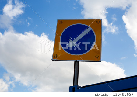 Reflective traffic sign with illuminated elements to enhance visibility and safety on urban roads. Featuring clear directional arrow, this modern sign provides crucial guidance for drivers Reflective traffic sign with illuminated elements to enhance visibility and safety on urban roads. Featuring clear directional arrow, this modern sign provides crucial guidance for drivers 130496657