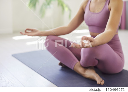 Close-Up Of Woman Meditating In Lotus Pose 130496971