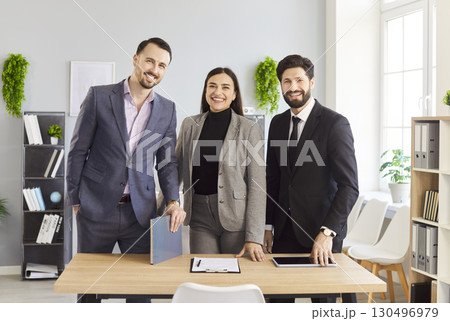 Group portrait of happy business partners team in modern office, successful employees standing Group portrait of happy business partners team in modern office, successful employees standing 130496979